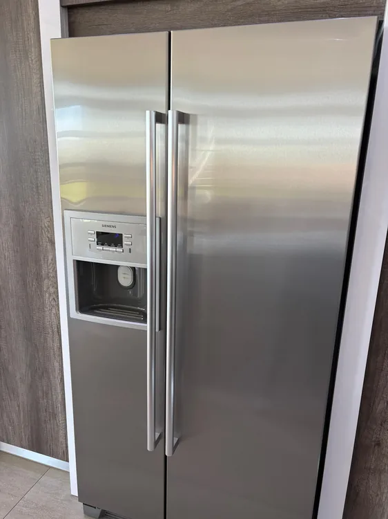 Technician providing fridge repair service in Durban North