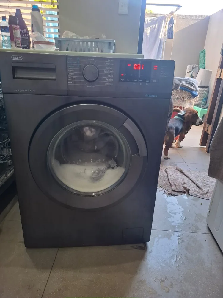 Technician providing tumble dryer repair service in Durban North